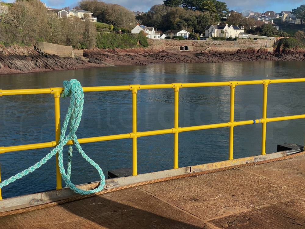 Interclamp double rail handrail, powder coated yellow for enhanced corrosion protection installed on a jetty